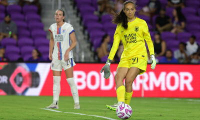 Phallon Tullis-Joyce passes the ball for the Seattle Reign during a game against the Orlando Pride in 2023.
