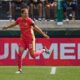 Portland Thorns forward Christine Sinclair celebrates after scoring a goal. She is running with both arms out to her sides like she is flying.