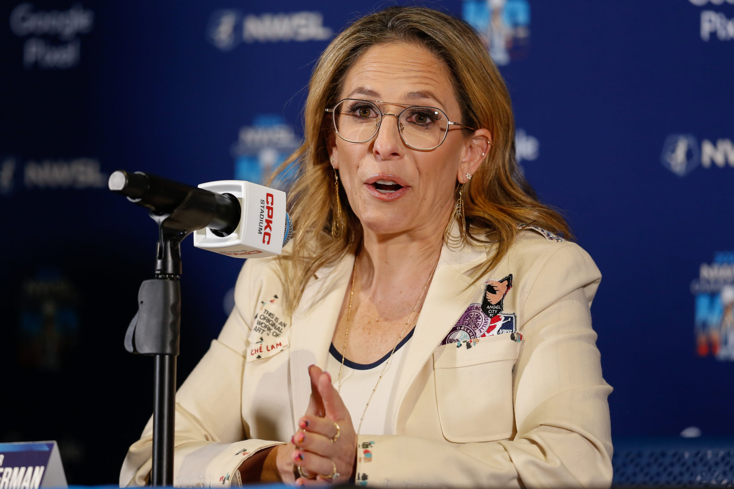 Jessica Berman speaks into a microphone at a press conference.