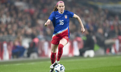 Rose Lavelle dribbles the ball with no defenders in sight.
