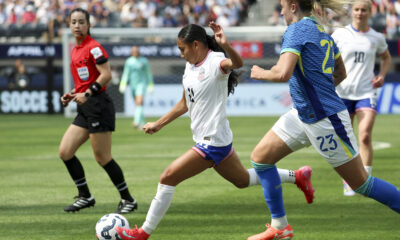 Alyssa Thompson controls the ball against Brazil defender Isa Haas.