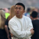 Masaki Hemmi wears a white sweater and looks on from the touchline during a Chicago Stars FC match on June 7.