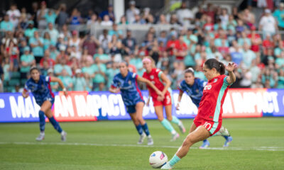 Lo'eau LaBonta winds up for a shot. Several North Carolina and Kansas City players trail her.